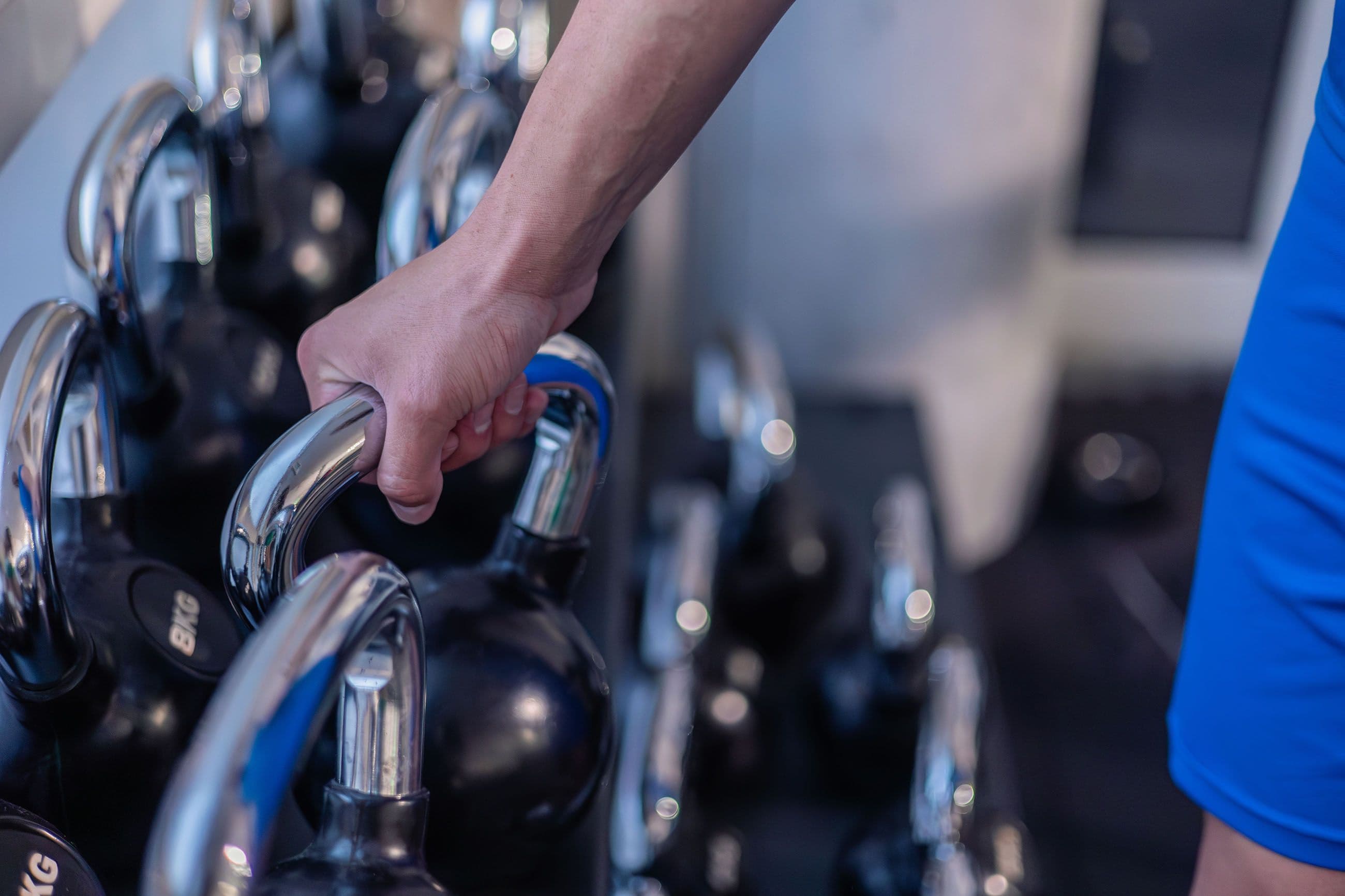 closeup hand of athlete gripping kettlebell